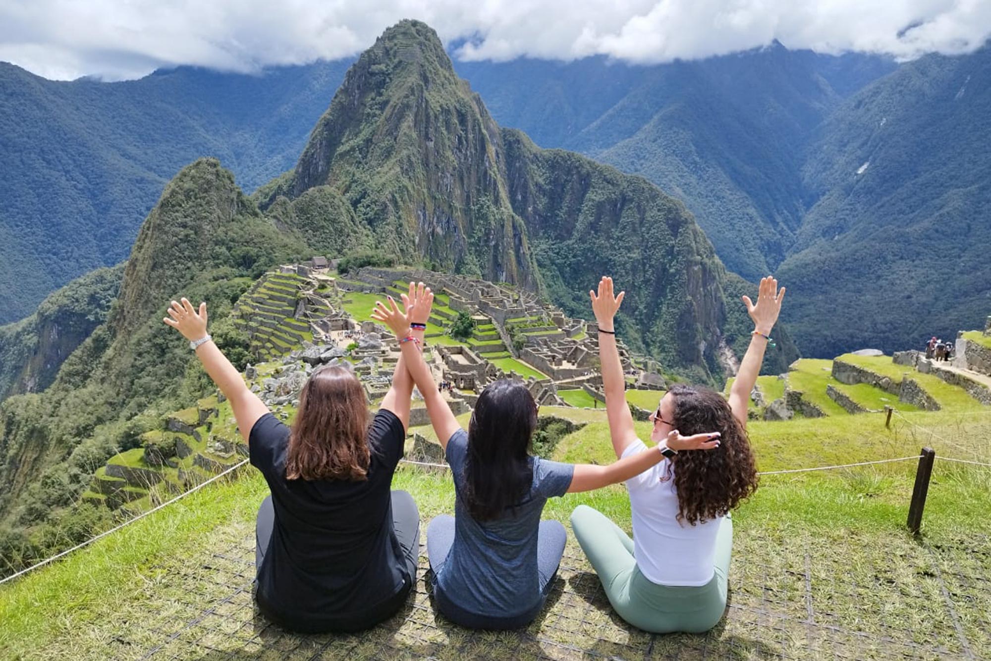 Friends enjoying the panoramic view of Machu Picchu during their visit